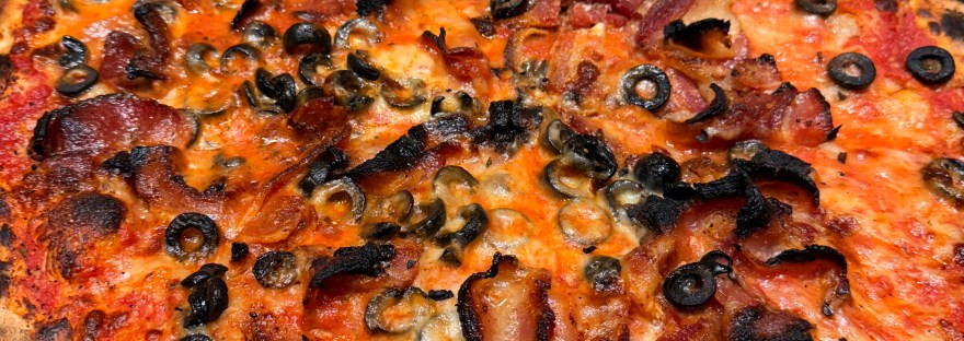 bacon and olive pizza in a box